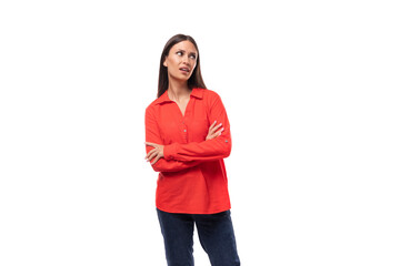 young confident brunette secretary woman dressed in a red shirt clasped her hands in front of her on a white background with copy space