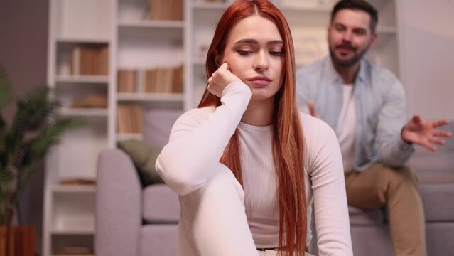 Portrait of young woman feeling stress and pressure from her husband or boyfriend while he screaming at her Sad male suffering from depression anxiety loneliness or mental health problem Home abuse