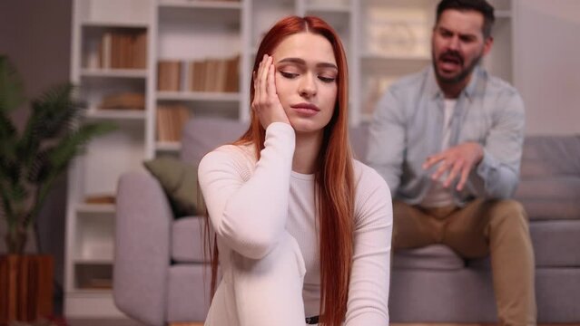 Portrait of young woman feeling stress and pressure from her husband or boyfriend while he screaming at her Sad male suffering from depression anxiety loneliness or mental health problem Home abuse