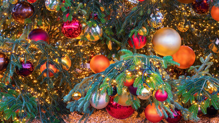 Anamorphic closeup of a decorated and illuminated Christmas tree at the christmas market in in...