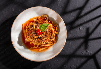 Bolognese pasta with ground beef, grated parmesan, tomato and basil