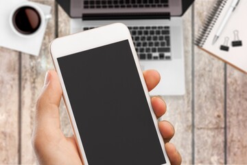 Hand hold smartphone with a blank screen