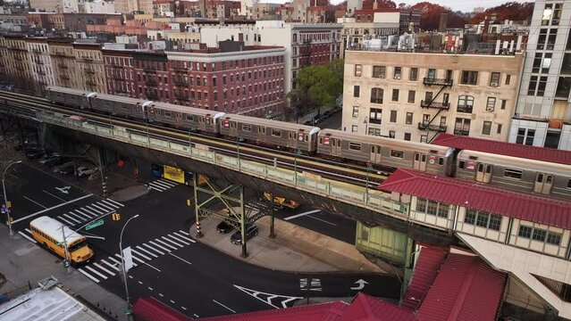 Aerial shot of New York City's 1 train passing through Harlem on an autumn morning.