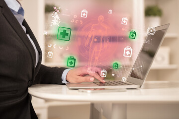 Doctor working on laptop with healthcare concept