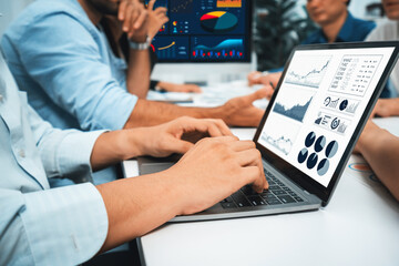 Analyst team uses BI Fintech display laptop to analyze financial data . Business people analyze BI software technology dashboard power for insights power into business marketing planning. Prudent