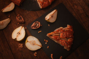 pear pie on a black serving board on a wooden table