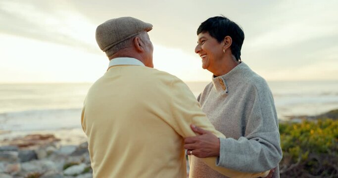 Dance, sunset and elderly couple at beach, funny and laughing on holiday. Romantic, senior man and woman at sea, smile and enjoy time together in retirement with love on vacation outdoor at ocean.