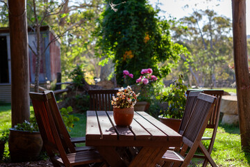 Obraz premium table and chairs in garden