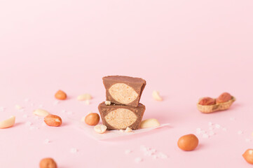 Tasty chocolate peanut butter cups on color background