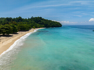 Tropical beach with white sand, turquoise water and waves. Samal, Davao. Philippines.