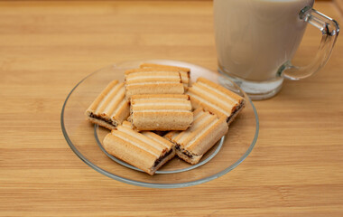 Appetizers, baked yellow flour filling Placed on a wooden table with milk in a glass