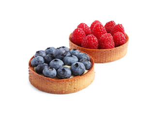 Tartlets with different fresh berries isolated on white. Delicious dessert