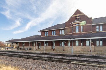 Fototapeta na wymiar Historic 19th century brick and stone passenger railway depot in Mankato, Minnesota (with lens flair)
