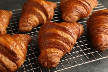 Delicious fresh croissants on grey table, closeup