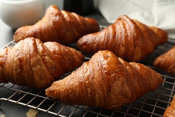 Delicious fresh croissants on grey table, closeup