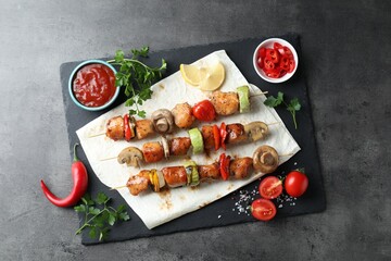 Delicious shish kebabs served on grey table, top view