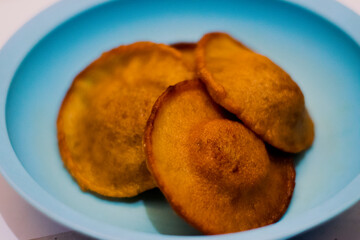 Kue Kucur or Kucur or kuih cucur, and called khanom fak bua or khanom jujun in Thai. It is a popular traditional snack in Southeast Asia, including Indonesia, Malaysia and Southern Thailand.