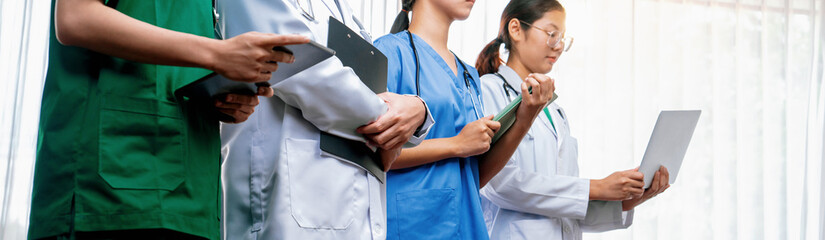 Confident and professional team of medical staff stand in line together as healthcare service and...