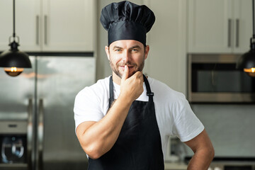 Chef on kitchen. Professional chef man in uniform on kitchen. Bearded chef, cook or baker. Male...