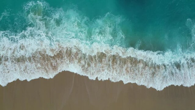 Top view of the los cabos beach in Mexico. Aerial drone footage of sea waves reaching shore in the coast.