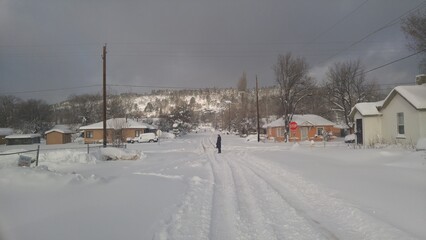 person on a street in the snow