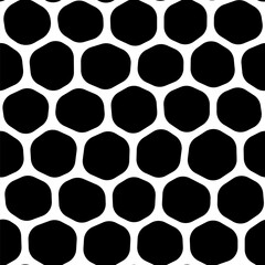 An abstract pattern with a bold black and white honeycomb motif on a white background, featuring a mesh-like design