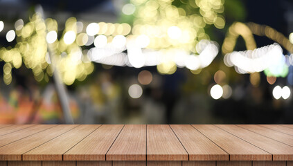 Empty wooden table top with lights bokeh on blur restaurant background.