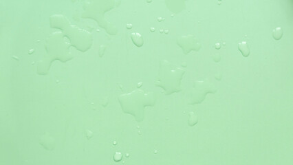 Water drops over a green background for creative poster design.
