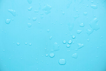 Water drops over a blue background for creative poster design.