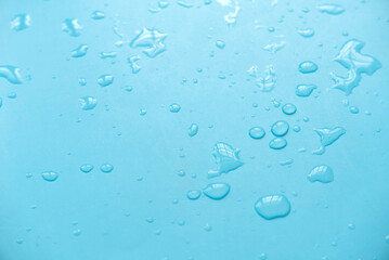 Water drops over a blue background for creative poster design.