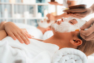 Serene ambiance of spa salon, couple indulges in rejuvenating with luxurious face cream massage with modern daylight. Facial skin treatment and beauty care concept. Quiescent