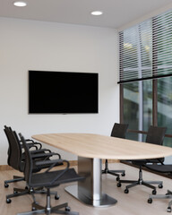 Interior design of a modern meeting room with a meeting table and a TV screen on the wall.
