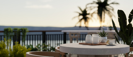 A table with a coffee mug tray on a beautiful balcony with garden and beautiful nature view.