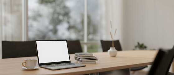 A laptop mockup on a meeting table in a modern meeting room. place of work, corporate job