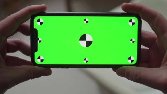 Close-up of latest smartphone technology with integrated green screen