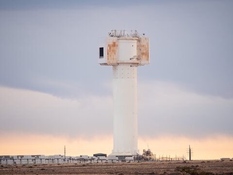 Khi Solar One concentrated solar tower with moody sunrise clouds