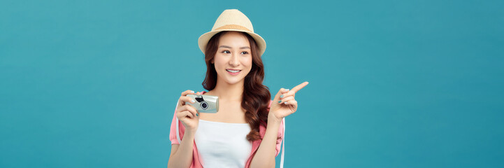 young attractive Asian woman traveler in casual clothes wearing straw hat with camera