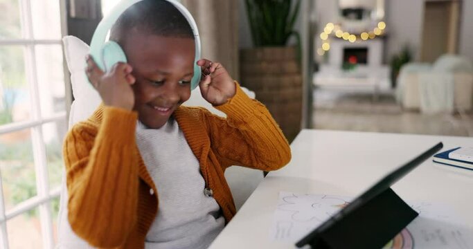 Headphones, music and child dancing with a tablet while watching a video on social media or the internet. Digital technology, moving and African boy kid listening to a song, playlist or album at home