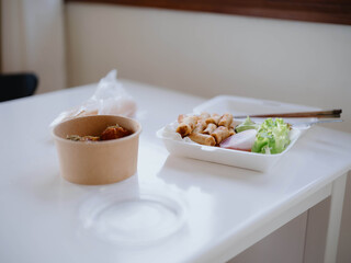 Food from delivery on the table in plastic utensils, a fast food concept
