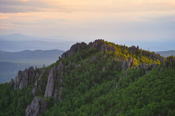 Evening clouds over the mountain rocks of Taganay