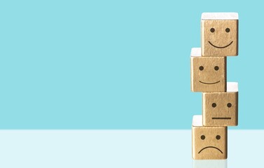 Satisfaction survey. Wooden cube with face symbol.