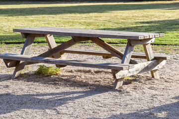 wooden bench in the park in morning sunlight