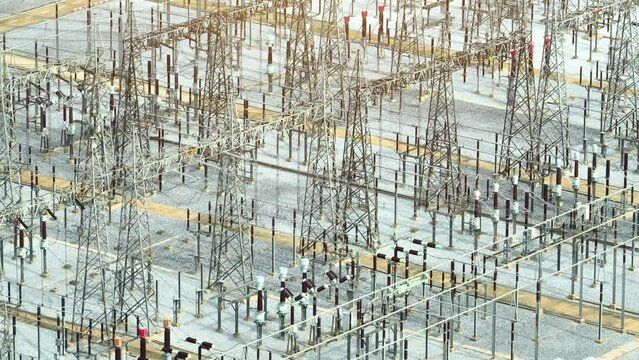 This high voltage power station utilizes cutting-edge equipment and advanced electrical systems to efficiently transmit electricity at high voltage levels, ensuring reliable power supply. Aerial view.
