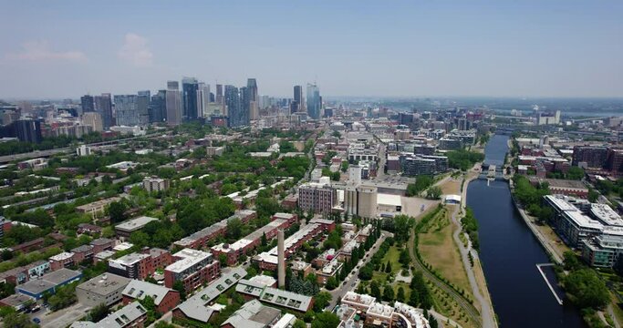 Aerial view flying over a neighborhood with downtown Montreal background