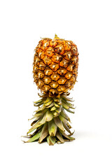 Inverted ripe pineapple on white background