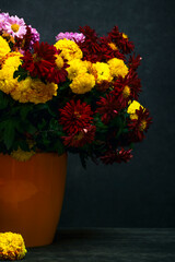 Still life with a bouquet of chrysanthemums in a yellow vase