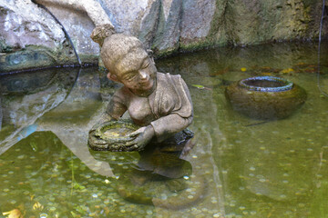 statue of Thai angel in the pond