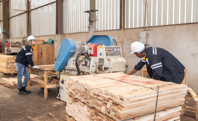 Fototapeta premium Woodworkers operate machines, tend lathes to cut, shape wood fixtures in manufacturing process