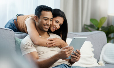 Happy, hug and couple with tablet on sofa relax with social media, movies or streaming film at...