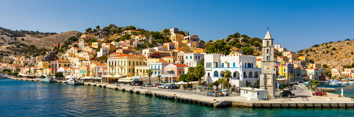 View of the beautiful greek island of Symi (Simi) with colourful houses and small boats. Greece,...